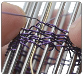 Wire being wrapped around jig pegs